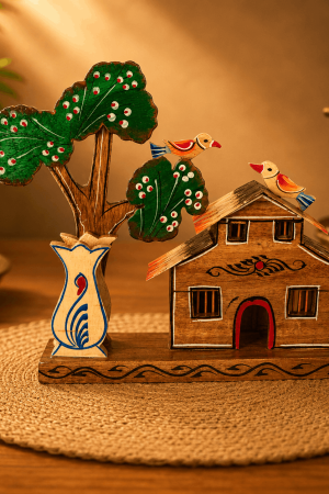 Handmade Wooden Village House Showpiece Bring the peaceful beauty of countryside living into your home with this handcrafted wooden village house showpiece. Carefully designed by skilled Indian artisans, this decorative masterpiece combines a traditional village house, vibrant birds, a handcrafted tree, and an elegant flower vase to create a charming display. Made from premium quality natural wood, every detail is hand-painted with care, giving each piece its own unique character. The rustic finish and traditional artwork make it an attractive decorative item for modern as well as classic interiors. Whether displayed on a living room table, office desk, bookshelf, TV unit, reception counter, or display cabinet, this handcrafted wooden décor creates a warm and welcoming atmosphere. Its timeless design also makes it an excellent gift for housewarming ceremonies, birthdays, anniversaries, weddings, festivals, and corporate occasions. A perfect collectible for anyone who appreciates authentic Indian handicrafts and handmade wooden art. Key Features Handmade by skilled Indian artisans Premium quality natural wood construction Beautiful village house with tree and birds design Hand-painted traditional artwork Eco-friendly and durable Lightweight yet sturdy Rustic finish for elegant interiors Suitable for home and office decoration Ideal gift for family, friends, and colleagues Unique handcrafted collectible Perfect For Living Room Decoration Office Desk Decor Study Table Decoration Bookshelf Display TV Unit Decoration Reception Counter Decor Housewarming Gift Birthday Gift Wedding Gift Festival Gift Corporate Gift Traditional Indian Home Decor Care Instructions Clean with a soft dry cloth. Avoid excessive moisture. Keep away from prolonged direct sunlight. Handle carefully to preserve the hand-painted finish. Product Specifications Attribute Details Material Natural Wood Product Type Handmade Wooden Village House Showpiece Style Traditional Indian Handicraft Finish Hand Painted Theme Village House with Tree & Birds Placement Living Room, Office, Shelf, Desk Gift Suitable Yes Country of Origin India SEO Keywords Handmade Wooden Village House Showpiece Wooden Village House Decor Wooden House Showpiece Wooden Home Decor Wooden Tree Decor Wooden Bird Showpiece Indian Wooden Handicraft Rustic Wooden Home Decor Handmade Wooden Decor Traditional Wooden Showpiece Village Theme Decor Wooden Table Decor Wooden Office Decor Wooden Shelf Decor Indian Heritage Decor Artisan Wooden Craft Wooden Decorative Item Wooden Gift Item Eco Friendly Wooden Decor Wooden Living Room Decor
